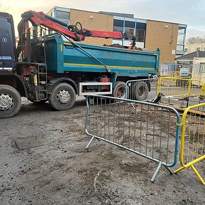 a blue dump truck parked in front of a building