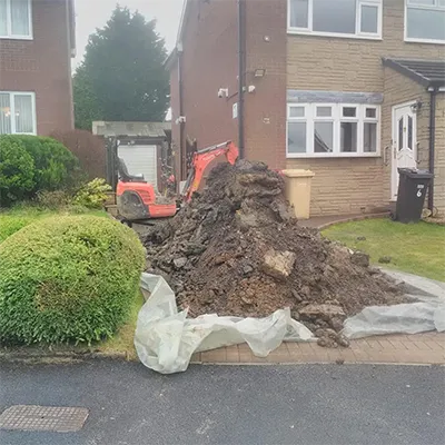 A pile of dirt in front of a house.